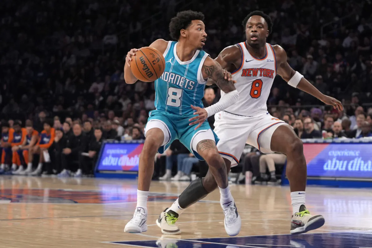 Charlotte Hornets' Nick Smith Jr., left, dribbles the ball against New York Knicks' OG Anunoby, right, during the first half of an NBA basketball game Thursday, Dec. 5, 2024, in New York. (Pamela Smith/AP Photo)