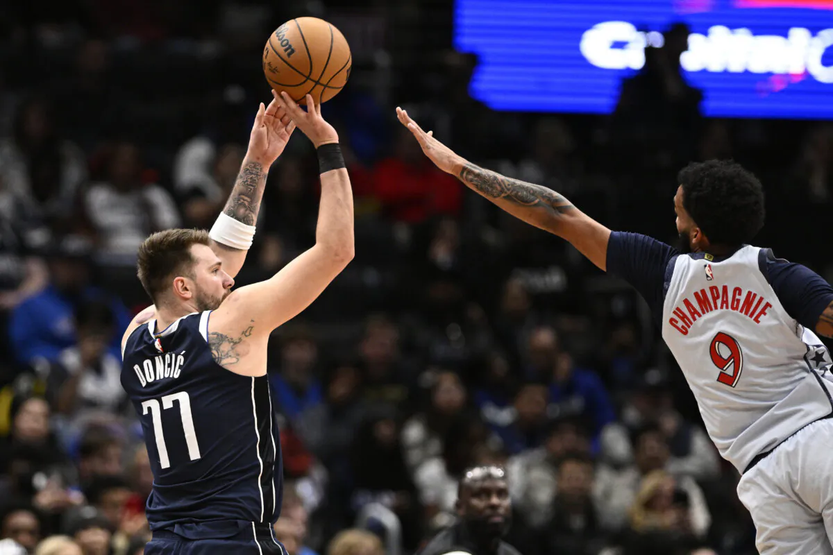 Dallas Mavericks guard Luka Doncic (77) looks to shoot against Washington Wizards forward Justin Champagnie (9) during the first half of an NBA basketball game, Thursday, Dec. 5, 2024, in Washington. (Nick Wass/AP Photo)