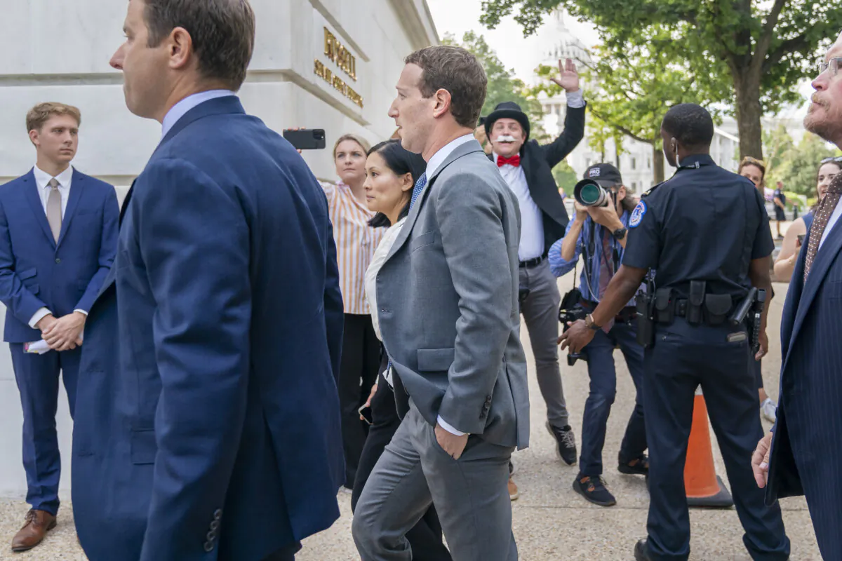 Meta CEO Mark Zuckerberg passes media and a protester as he arrives for a closed-door gathering of leading tech CEOs on Capitol Hill in Washington, on Sept. 13, 2023. (Jacquelyn Martin/AP Photo)