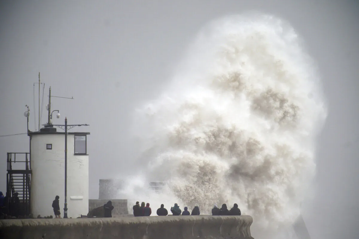 Waves crash during storm Darragh over the seafront in Porthcawl in Wales, on Dec. 7, 2024. (Ben Birchall/PA via AP)