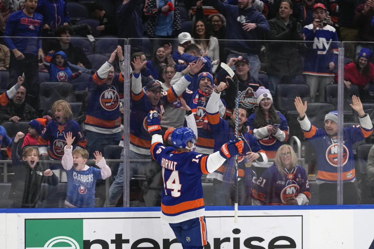 Fans cheer for New York Islanders' Bo Horvat (14) after Horvat scored a goal during the second period of an NHL hockey game against the Carolina Hurricanes Saturday, Dec. 7, 2024, in Elmont, N.Y. (Frank Franklin II/AP Photo)