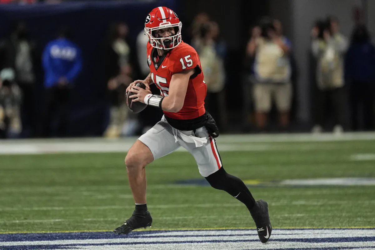 Georgia quarterback Carson Beck (15) runs out of the pocket against Texas during the first half of the Southeastern Conference championship NCAA college football game, Saturday, Dec. 7, 2024, in Atlanta. (John Bazemore/AP Photo)