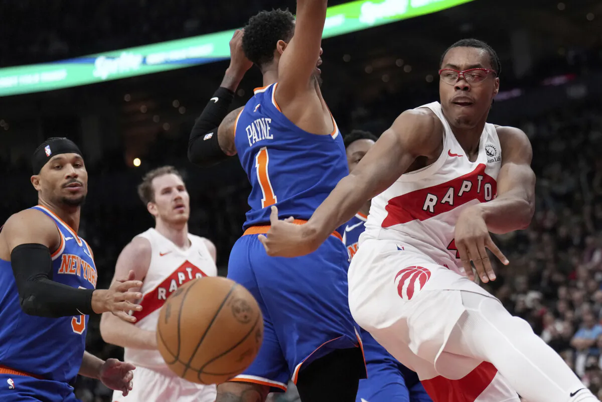 Toronto Raptors forward Scottie Barnes (4) moves the ball past New York Knicks guard Cameron Payne (1) during the first half of an NBA basketball game in Toronto, on Dec. 9, 2024. (Nathan Denette/The Canadian Press via AP)