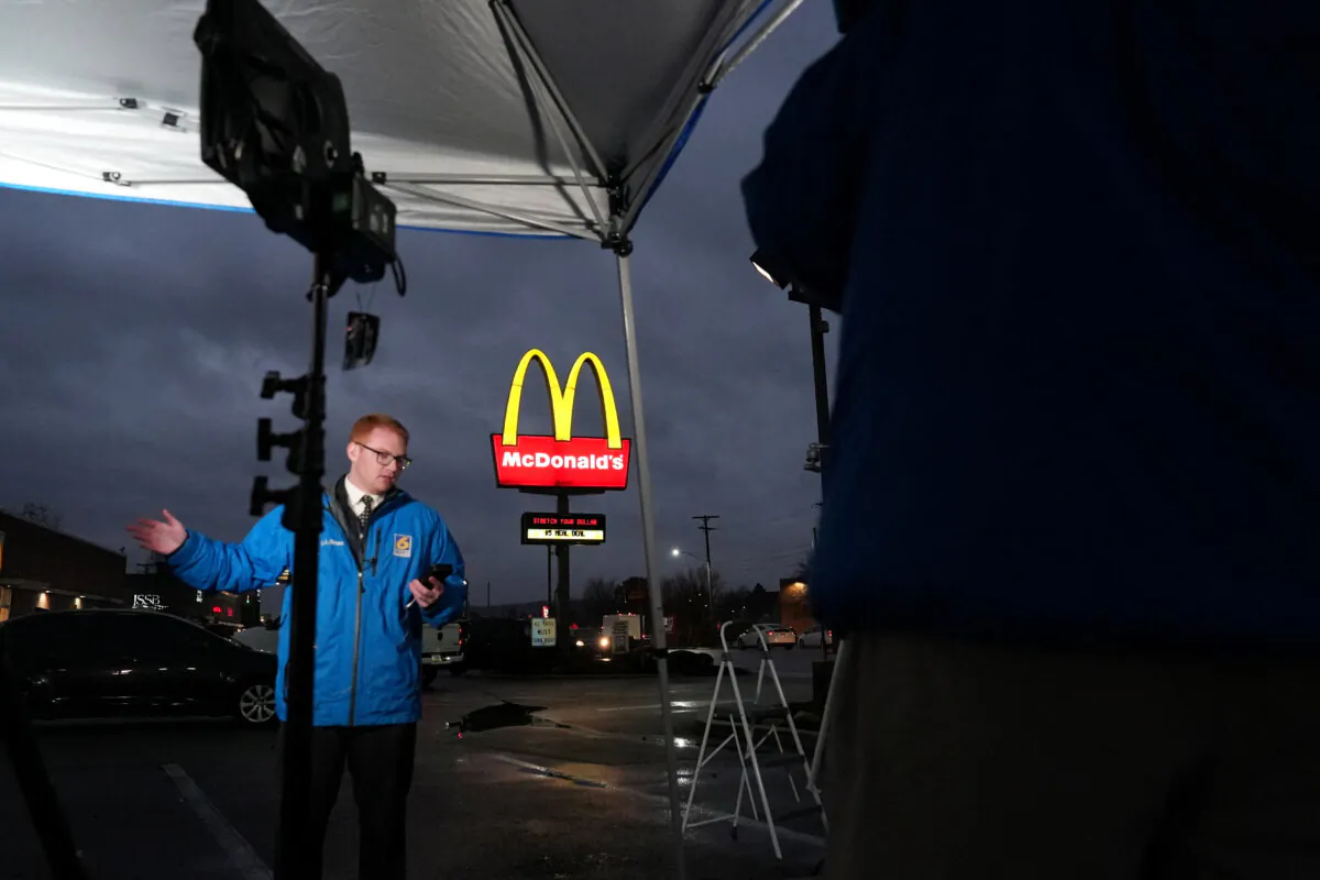 A television reporter broadcasts from outside a McDonald's restaurant where a suspect in the killing UnitedHealth executive Brian Thompson, identified as Luigi Mangione was arrested in Altoona, Pa., on Dec. 9, 2024. (Julio Cesar Chavez/Reuters)
