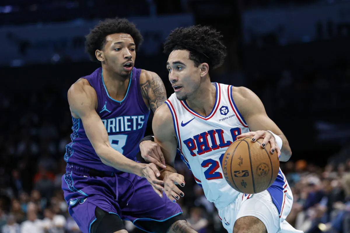 Philadelphia 76ers guard Jared McCain, right, drives into Charlotte Hornets guard Nick Smith Jr. during the second half of an NBA Cup basketball game in Charlotte, N.C., Tuesday, Dec. 3, 2024. (Nell Redmond/AP Photo)