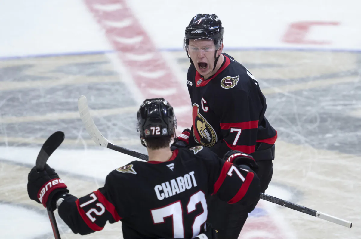 Ottawa Senators left wing Brady Tkachuk (7) celebrates after his winning goal with teammate Thomas Chabot (72) at the end of overtime NHL hockey game action against the Pittsburgh Penguins in Ottawa, Saturday, Dec. 14, 2024. (Adrian Wyld/The Canadian Press via AP)