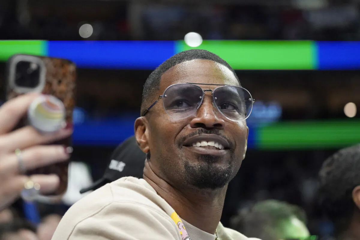 Jamie Foxx smiles during an NBA basketball game between the Washington Wizards and Dallas Mavericks in Dallas on Nov. 27, 2021. (LM Otero/AP Photo)