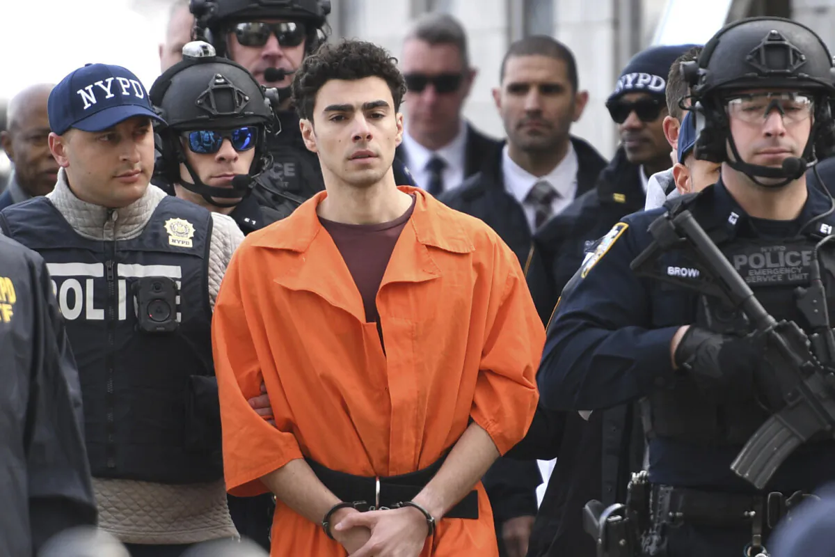 Luigi Mangione, a suspect in the fatal shooting of UnitedHealthcare CEO Brian Thompson, is escorted by police in New York on Dec. 19, 2024. (Pamela Smith/AP Photo)