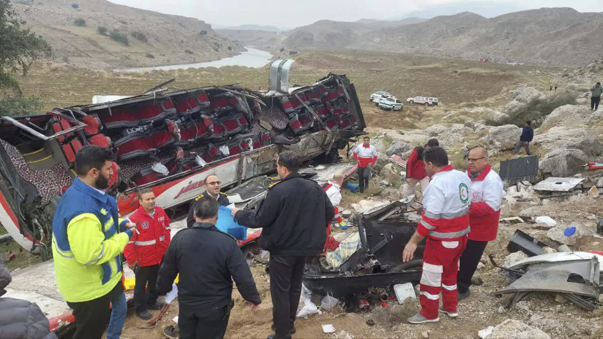 Rescue workers and police officers work at the scene of a fatal bus accident in Pa-alam, Iran, some 280 miles southwest of Tehran, Iran, on Dec. 21, 2024. (Iranian Red Crescent Society via AP)
