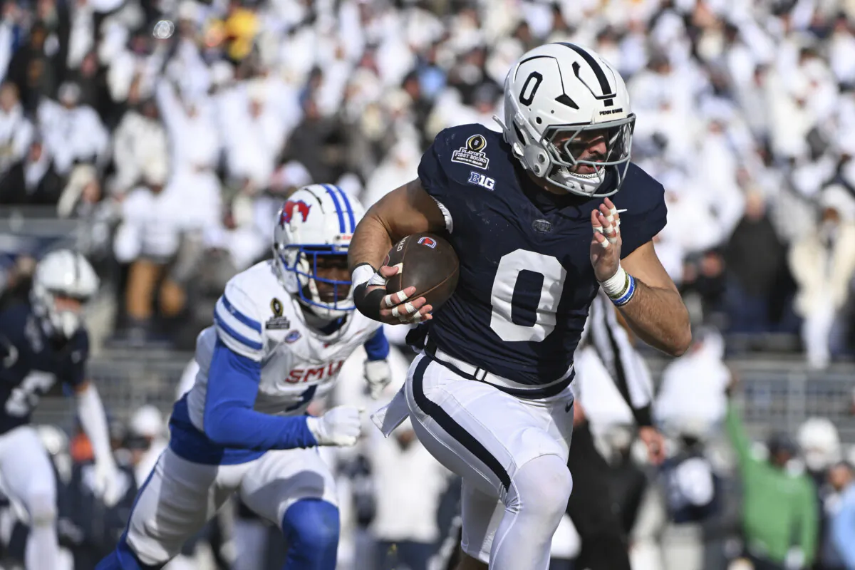 Penn State linebacker Dominic DeLuca returns an interception for a touchdown while being chased by SMU running back Brashard Smith during the first half in the first round of the NCAA College Football Playoff, Saturday, Dec. 21, 2024, in State College, Pa. (Barry Reeger/AP Photo)