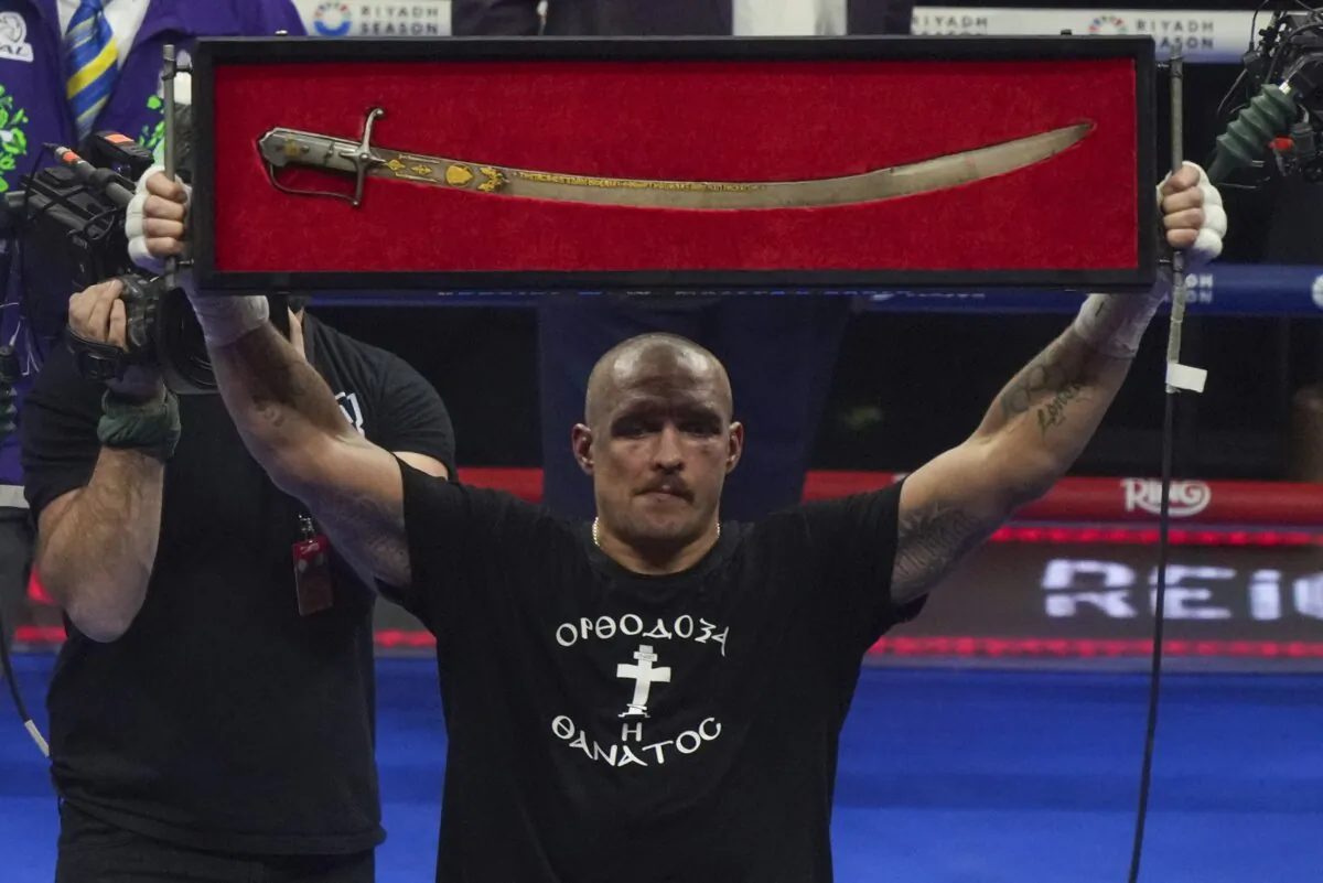 Ukraine's Oleksandr Usyk celebrates after winning the WBA, WBO, and WBC world heavyweight title fight against Britain's Tyson Fury in Riyadh, Saudi Arabia, Sunday, Dec. 22, 2024. (Frank Augstein/AP Photo)