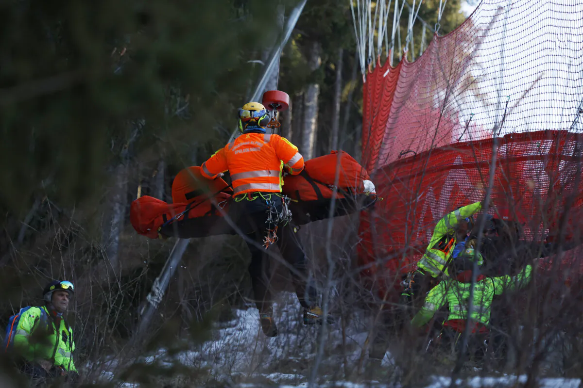 Medical staff are carrying France's Cyprien Sarrazin after crashing into protections net during an alpine ski, men's World Cup downhill training, in Bormio, Italy, on Dec. 27, 2024. (Alessandro Trovati/AP Photo)
