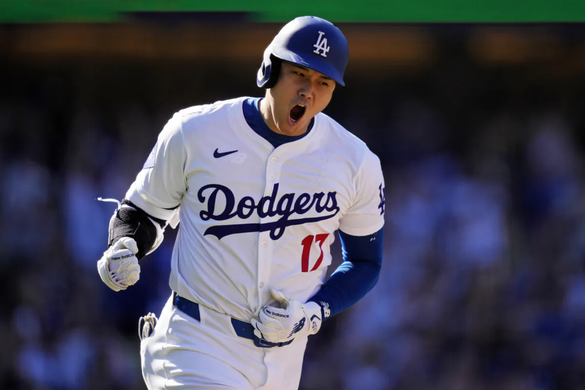 Los Angeles Dodgers' Shohei Ohtani celebrates as he heads to first for a solo home run during the ninth inning of a baseball game against the Colorado Rockies in Los Angeles on Sept. 22, 2024. (Mark J. Terrill/AP Photo)