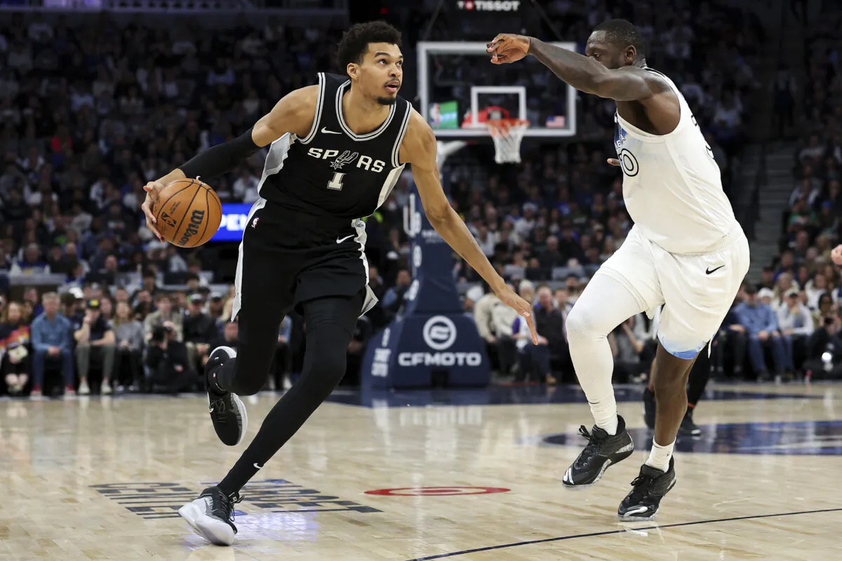San Antonio Spurs center Victor Wembanyama (L) works around Minnesota Timberwolves forward Julius Randle during the first half of a game in Minneapolis on Dec. 29. (Matt Krohn/AP Photo)