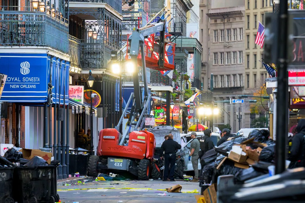 Police investigators surround a white truck that crashed into a work lift after its driver drove into a crowd of New Year's revelers, in the French Quarter of New Orleans, on Jan. 1, 2025. (Matthew Hinton/AFP via Getty Images)