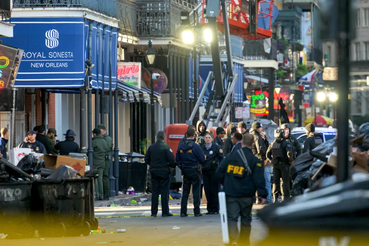 FBI investigators arrive at the scene where the white Ford F-150 pickup truck that crashed into a work lift after allegedly driving into a crowd of New Year's revelers in the French Quarter of New Orleans on Jan. 1, 2025. (Matthew Hinton/AFP via Getty Images)