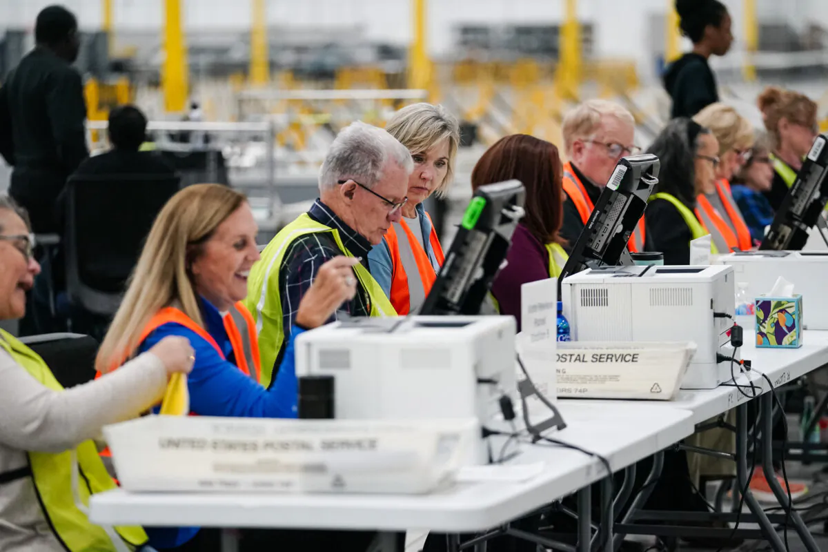 Fulton County elections workers process absentee ballots at the new Fulton County Elections Hub and Operations Center in Union City, Ga., on Nov. 4, 2024. (Elijah Nouvelage/AFP via Getty Images)