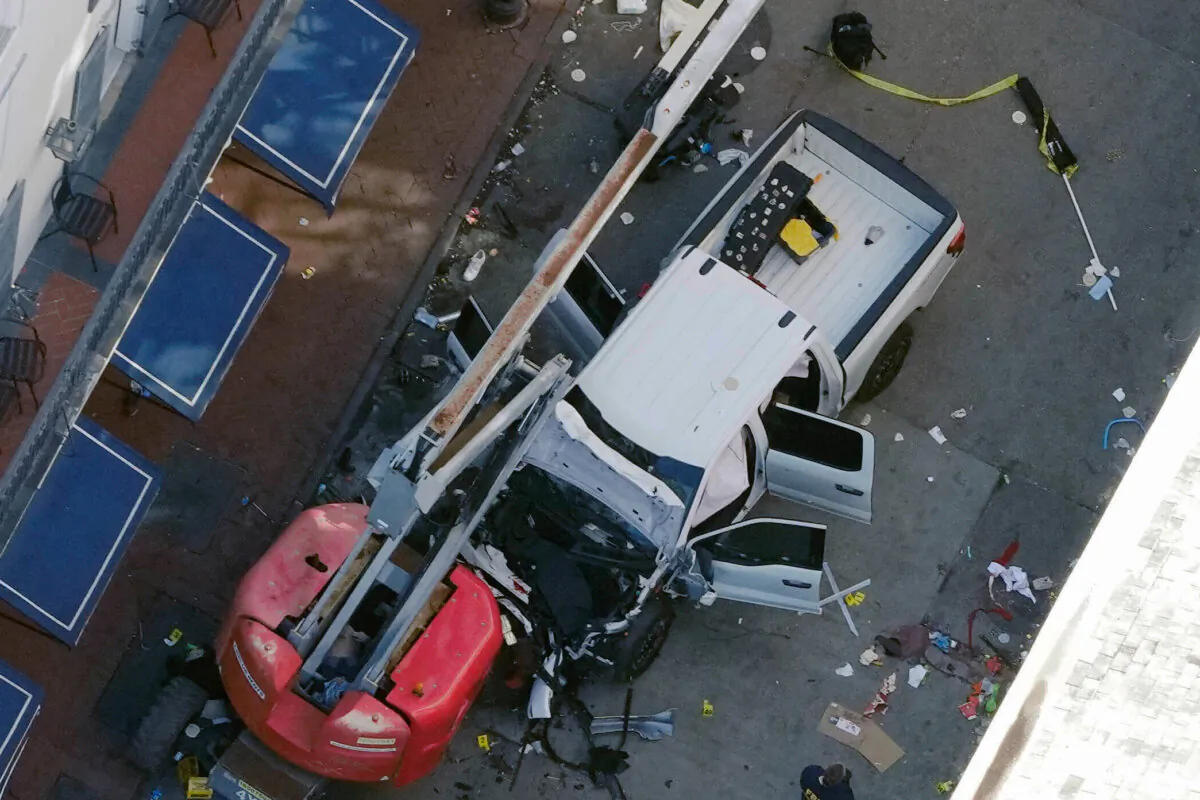 A black ISIS flag lies rolled up on the ground behind the Ford pickup truck that was driven into the crowd on Bourbon Street in New Orleans on Jan. 1, 2025. (Gerald Herbert/AP)