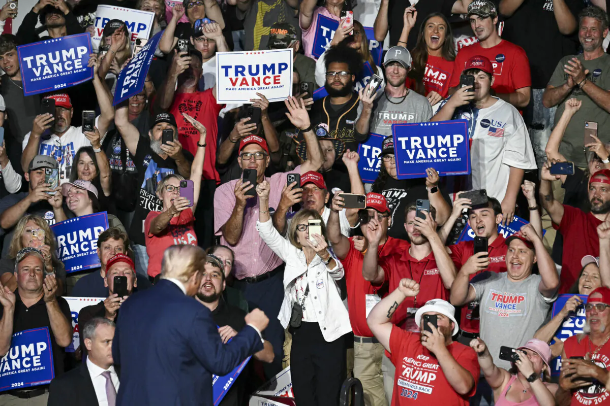 Supporters cheer as Donald Trump holds up his fist while arriving to speak at a campaign rally in Indiana, Pa., on Sept. 23, 2024. (Jim Watson/AFP via Getty Images)