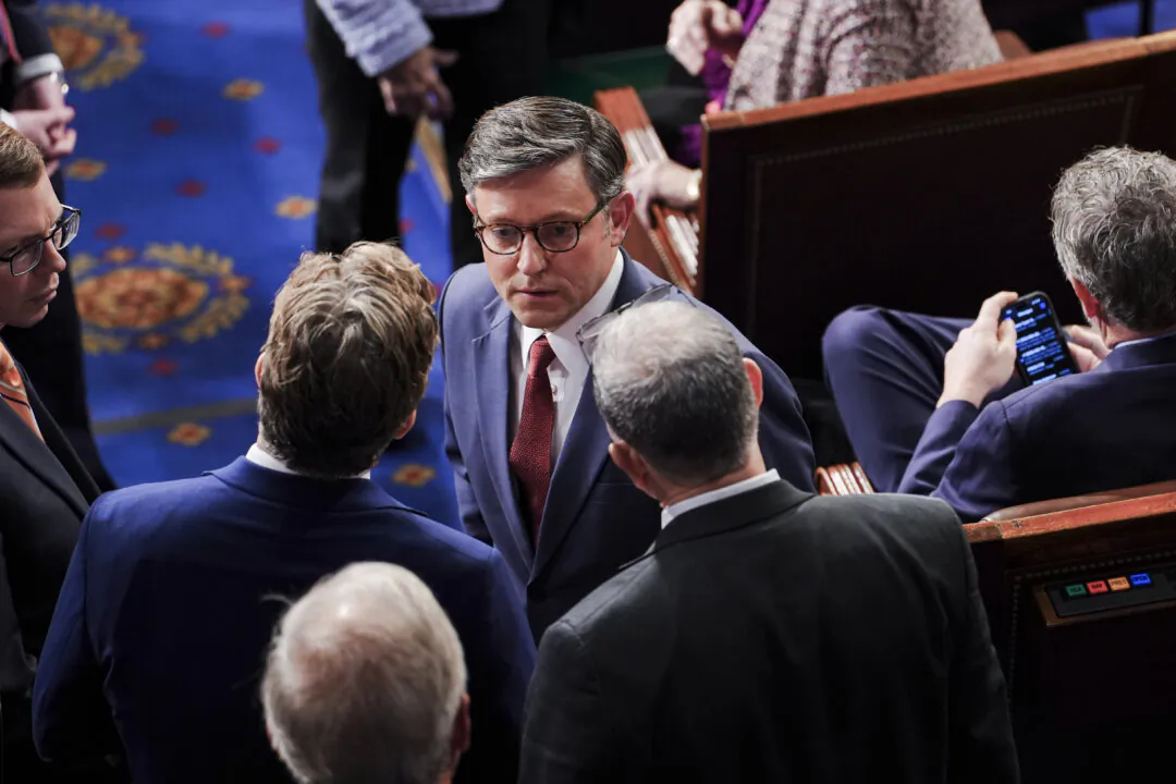 Mike Johnson (R-La.), nominee for speaker of the House, speaks with other lawmakers during the first sitting of the 119th Congress in Washington on Jan. 3, 2025. (Madalina Vasiliu/The Epoch Times)