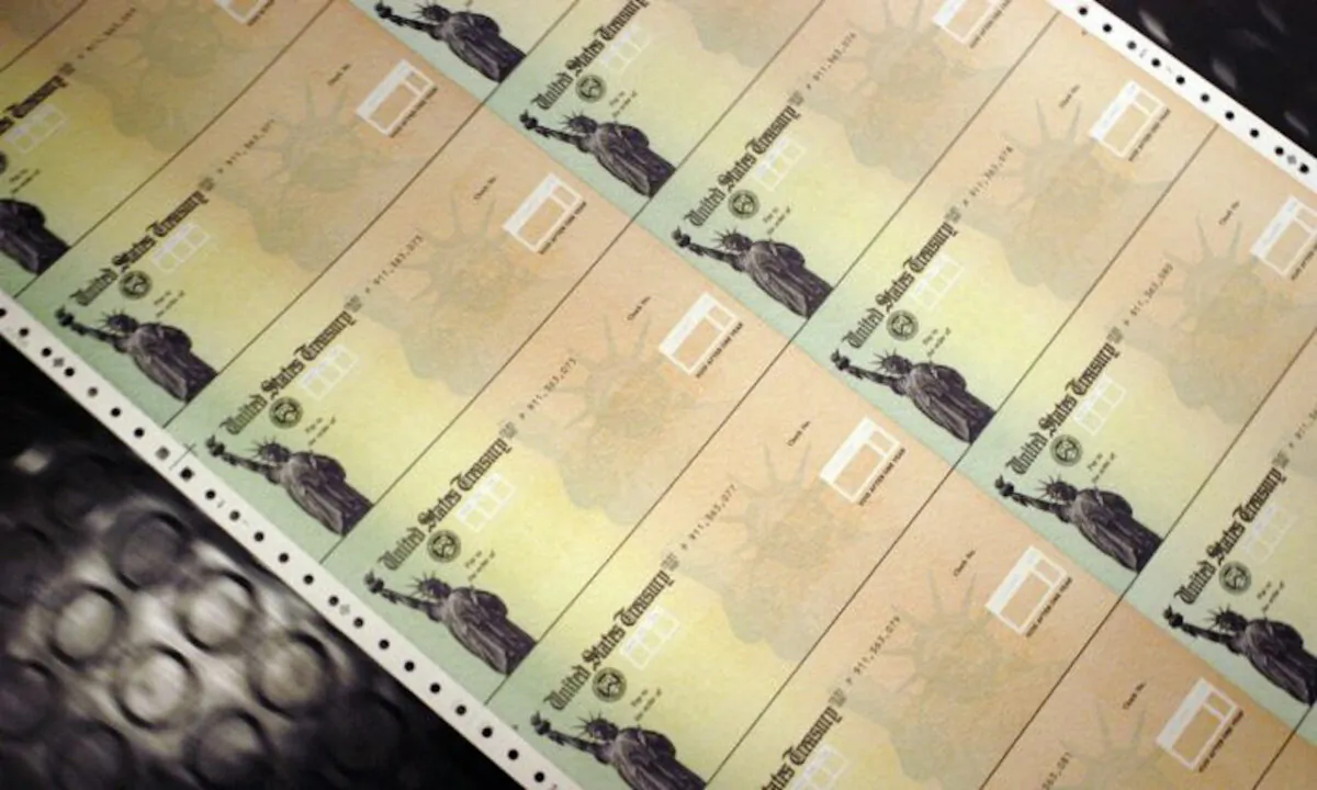 Blank government checks are run through a printer at the US Treasury printing facility in Philadelphia, Pa., on July 18, 2011. (William Thomas Cain/Getty Images)