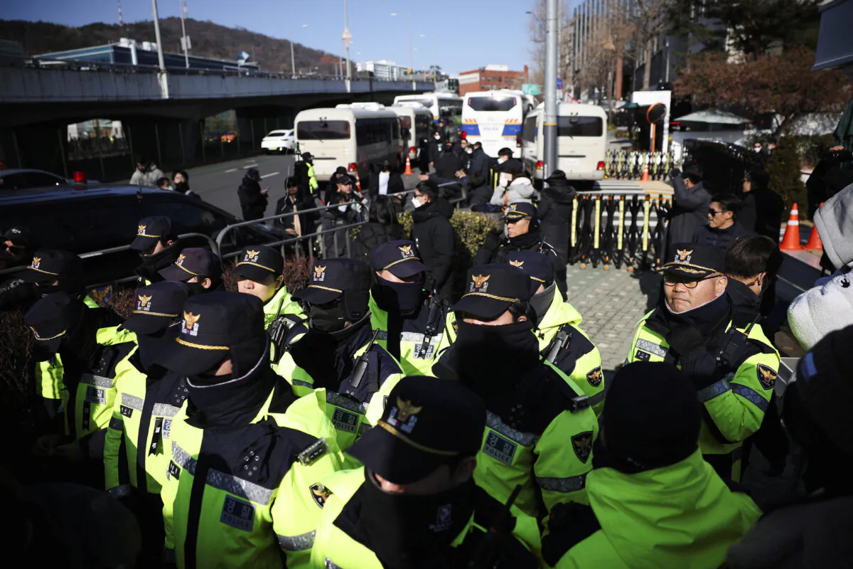 Police officers stand guard as Yoon supporters gather outside of impeached South Korean President Yoon Suk Yeol's official residence, in Seoul, South Korea, on Jan. 2, 2025. (Kim Hong-Ji/Reuters)
