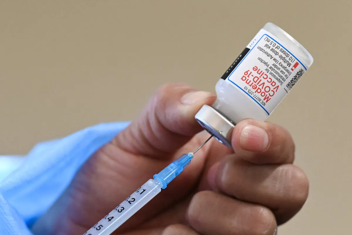 A nurse prepares a dose of the Moderna vaccine against COVID-19, donated by the United States, at a vaccination center in San Juan Sacatepequez, Guatemala, on July 15, 2021. (Johan Ordonez/AFP via Getty Images)