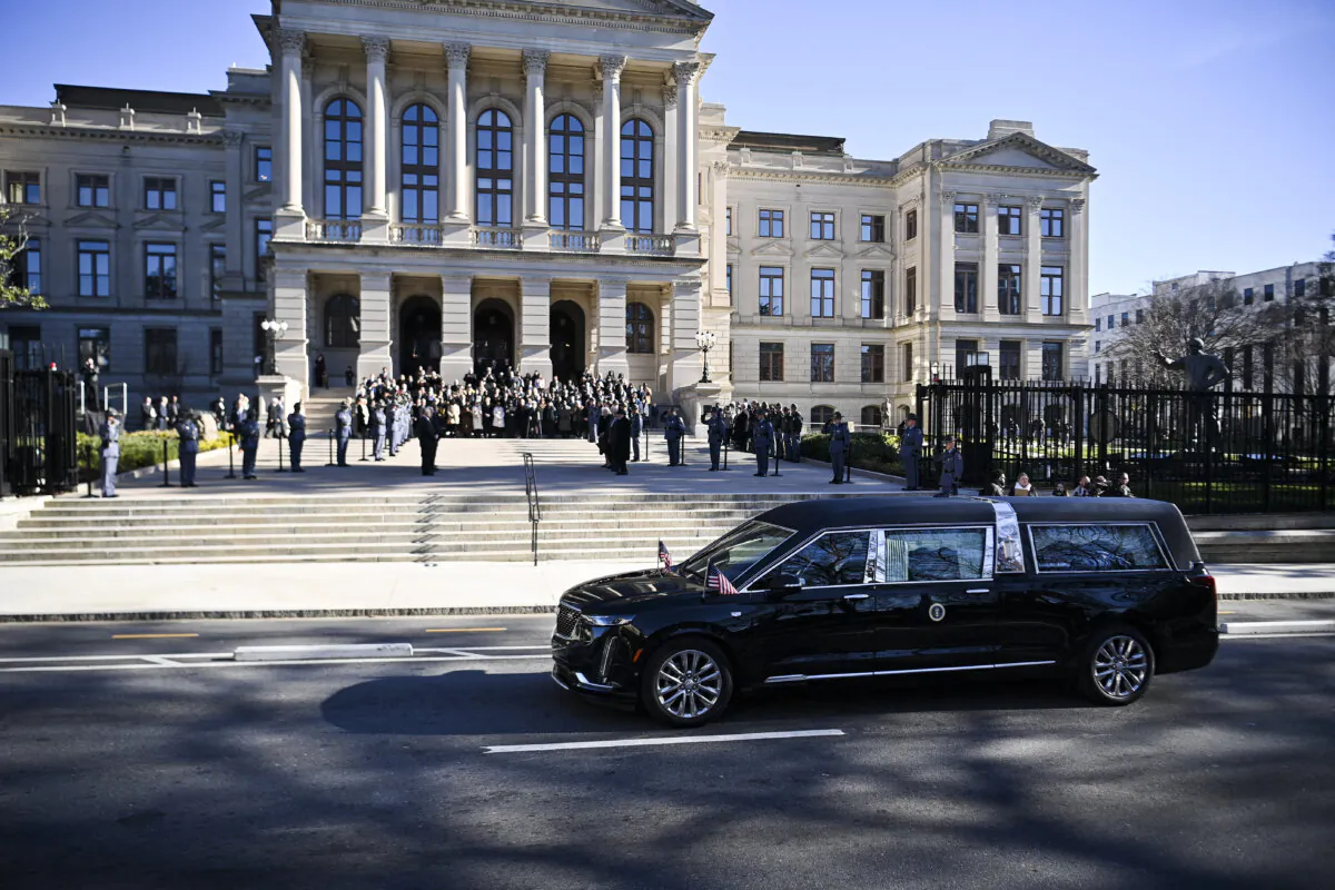 The hearse carrying the flag-draped casket of former President Jimmy Carter pauses outside the State Capitol in Atlanta, Ga., on Jan. 4, 2025. (Richard Pierrin/AFP via Getty Images)