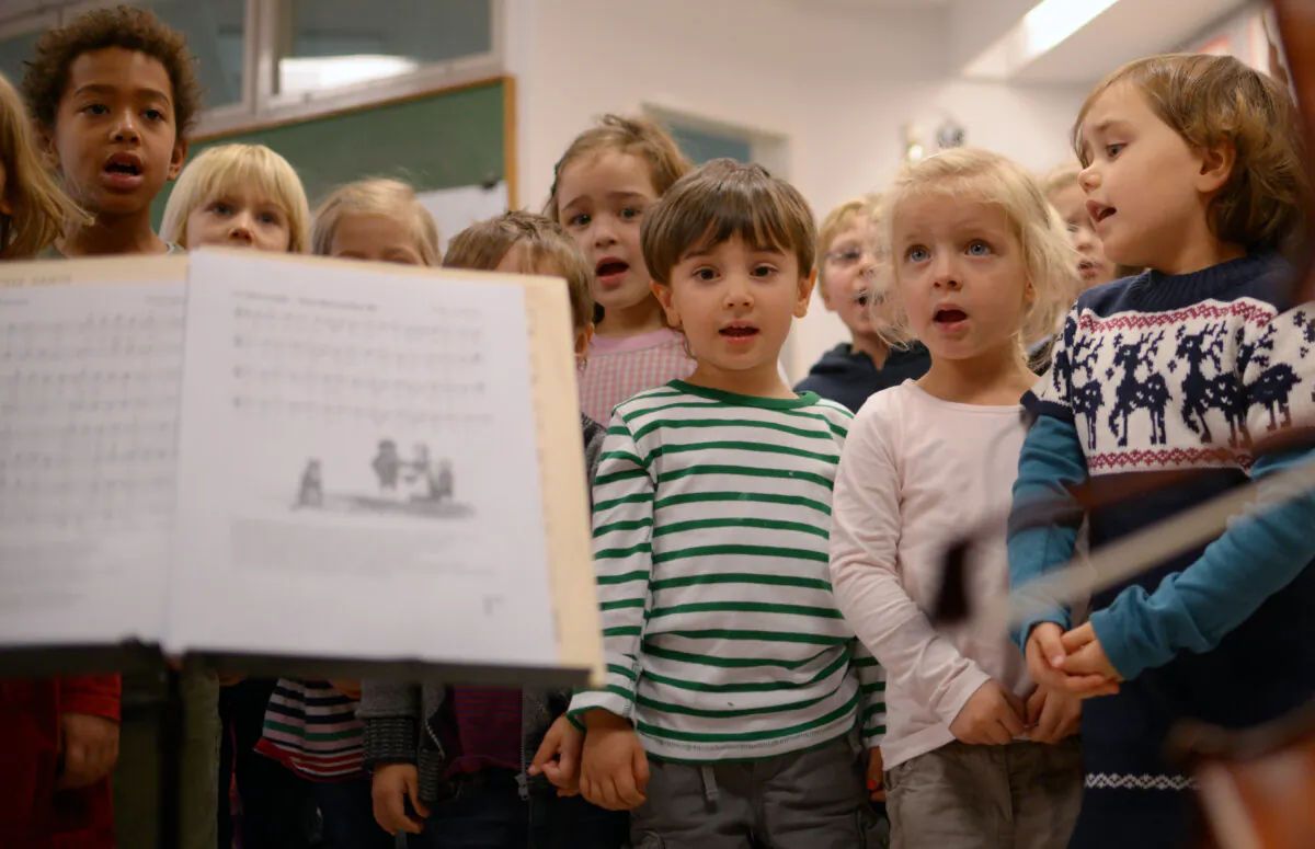 Children sing with two cellists (unseen) of the Staatskapelle Orchestra at the Musikkindergarten (music kindergarten) in Berlin as part of a music education program on Nov. 6, 2012. (Johannes Eisele/AFP via Getty Images)