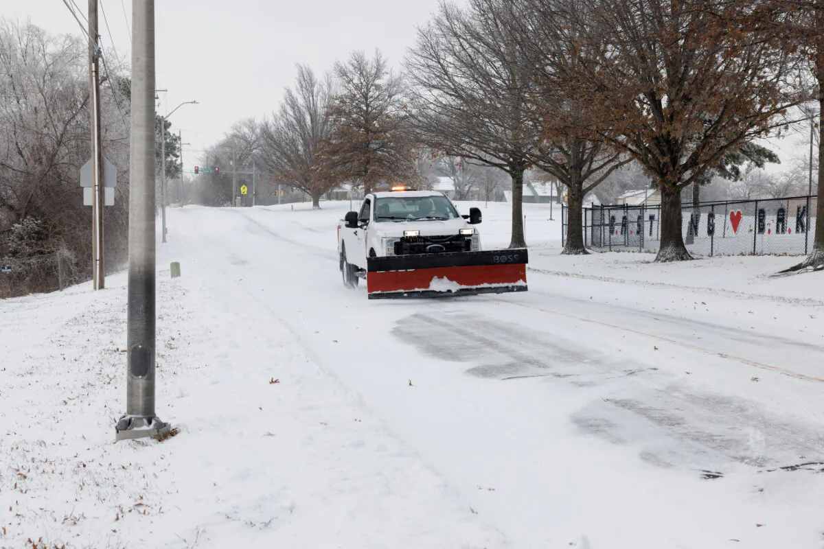A county truck with a snowplow drives down a road in Shawnee, Kan., on Jan. 5, 2025. (Chase Castor/Getty Images)