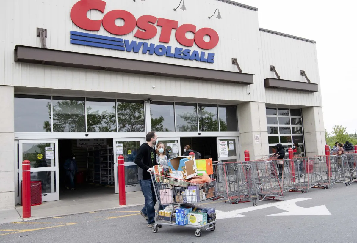 Shoppers walk out with full carts from a Costco store in Washington on May 5, 2020. (Nicholas Kamm/AFP via Getty Images)