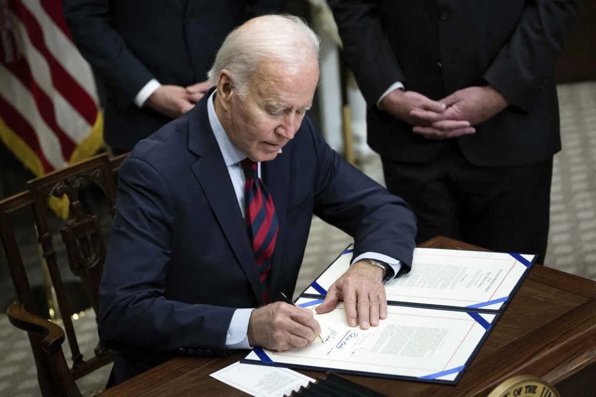 President Joe Biden signs a resolution in Washington on Dec. 2, 2022. (Brendan Smialowski/AFP via Getty Images)