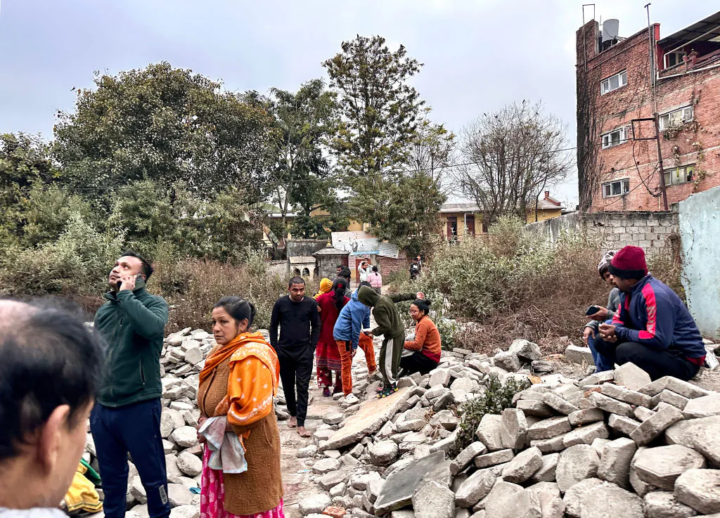 People gather in an open area following earthquake tremors in Kathmandu, in the early hours on Jan. 7, 2025. A powerful earthquake in China's remote Tibet region killed at least 32 people and collapsed "many buildings," Chinese media reported, with tremors also felt in neighboring Nepal's capital Kathmandu and parts of India. (Sunil Sharma/AFP via Getty Images)