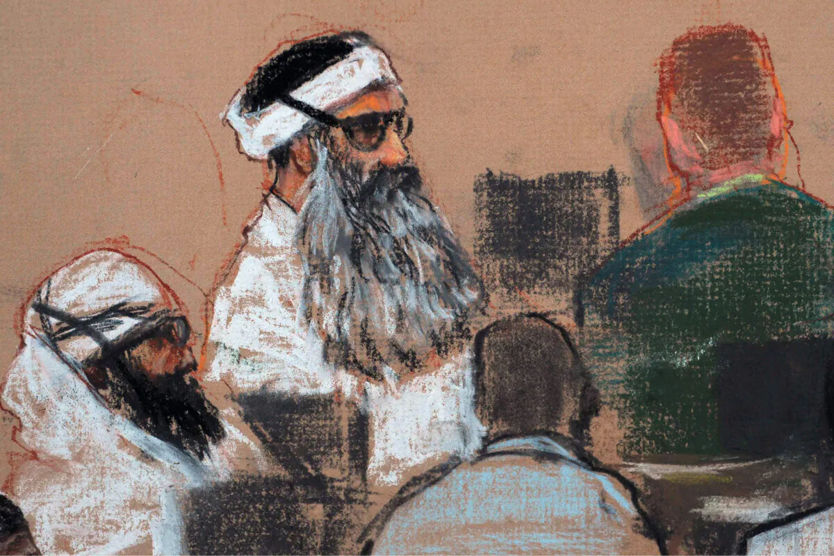 This Dec. 8, 2008, courtroom drawing by artist Janet Hamlin and reviewed by the U.S. military, shows Khalid Sheikh Mohammed, center, and co-defendant Walid Bin Attash, left, attending a pre-trial session at Guantanamo Bay Naval Base, Cuba. (Janet Hamlin, Pool/AP Photo)