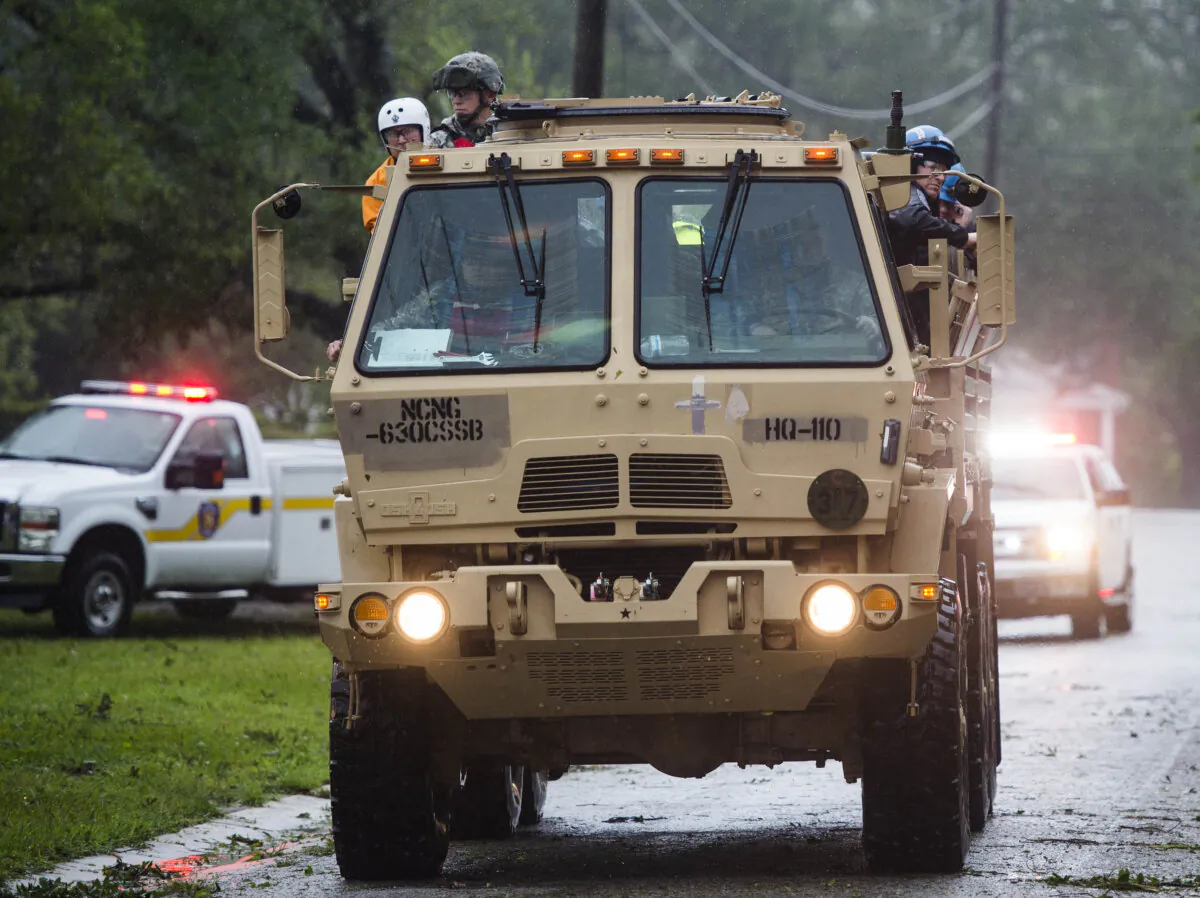 Members of the National Guard and a FEMA search and rescue team in a file photo. (Andrew Caballero-Reynolds/AFP via Getty Images)