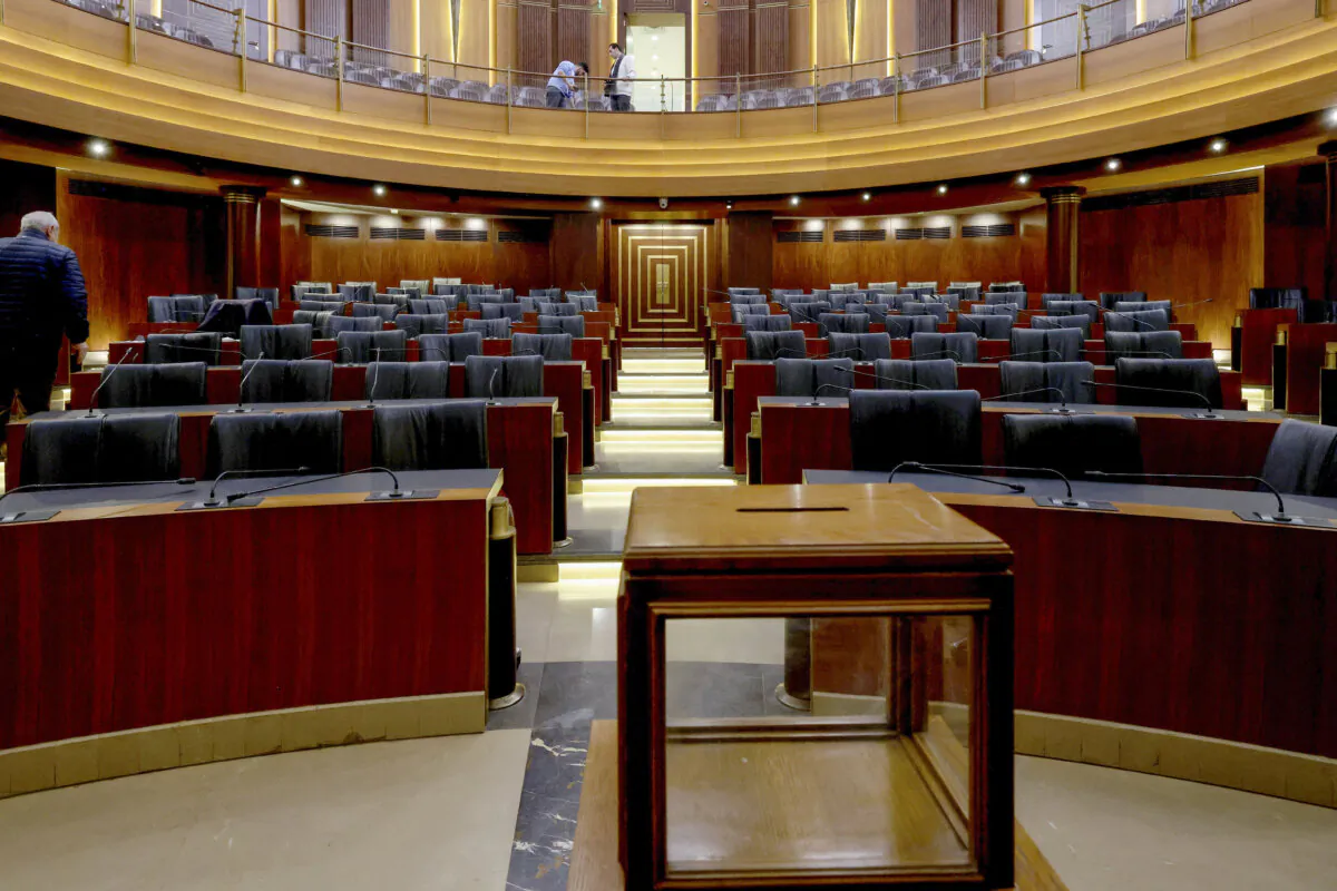 Staff members prepare the main chamber of the Parliament and set up a ballot box on the before a parliamentary session to elect a president, in Beirut on Jan. 8, 2025. (Anwar Amro/AFP via Getty Images)