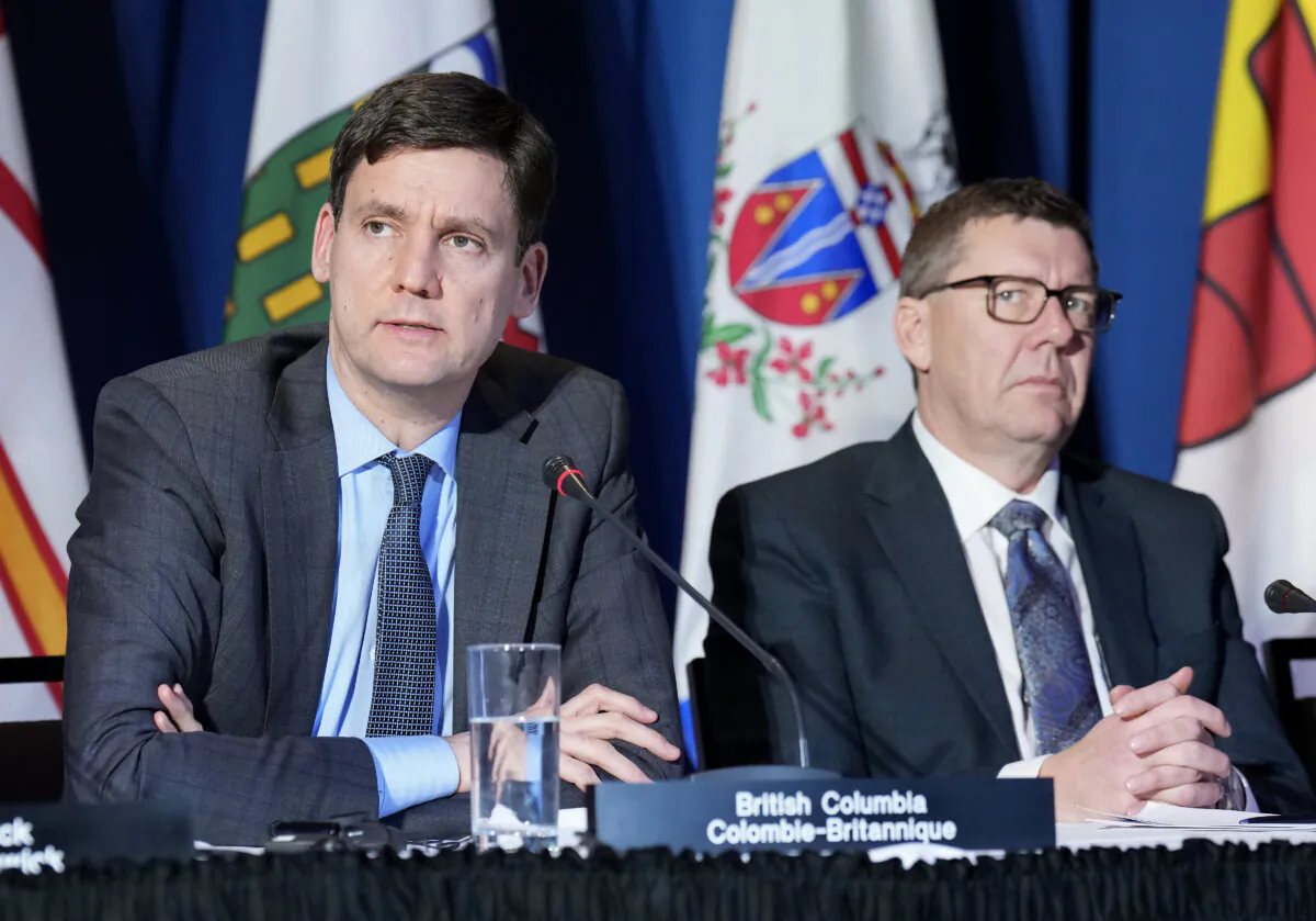 British Columbia Premier David Eby, left, and Saskatchewan Premier Scott Moe speak to the media during the fall meetings of Canada's premiers hosted by Ontario in Toronto on Dec. 16, 2024. (The Canadian Press/Nathan Denette)