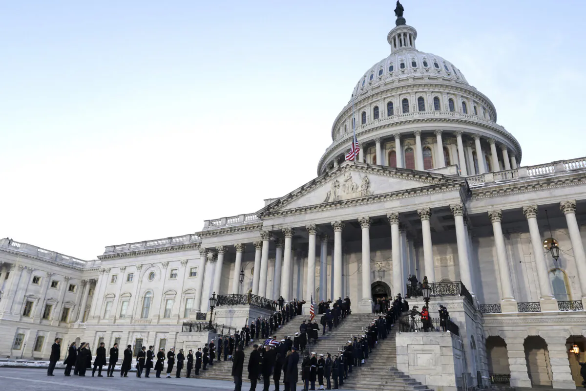 A joint services military body bearer team carries the flag-draped casket of former President Jimmy Carter up the steps into the U.S. Capitol in Washington on Jan. 7, 2025. (Evelyn Hockstein/Pool via AP)