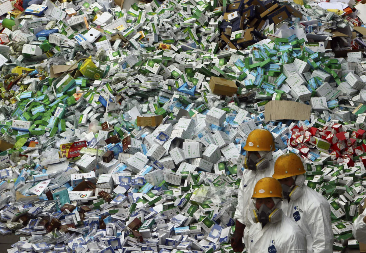 Workers prepare to destroy more than 50 tons of confiscated fake medicine during a campaign to mark World Consumer Rights Day in Beijing on March 15, 2012. (AP Photo/File)