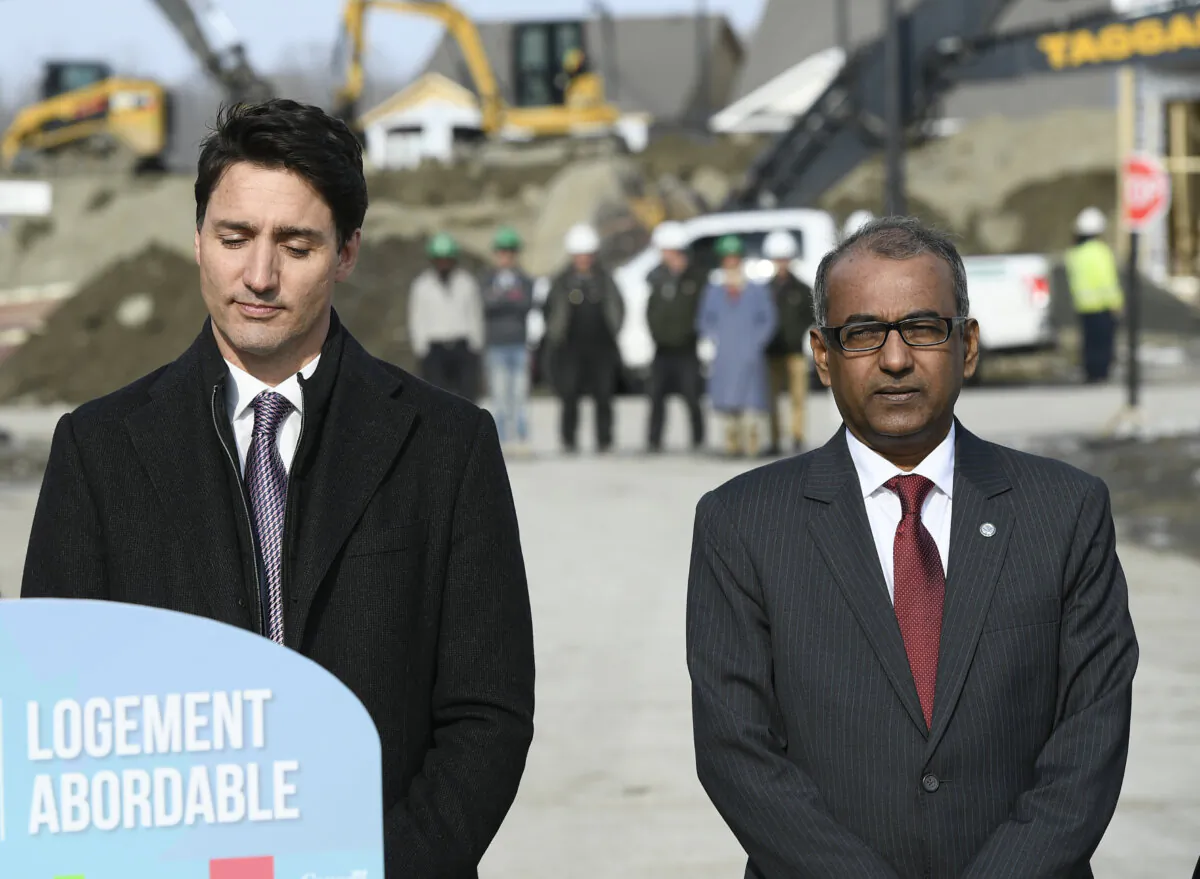 Liberal MP Chandra Arya stands with Prime Minister Justin Trudeau at a press conference highlighting the first-time home buyer incentive, at Tamarack Homes' Cardinal Creek Village development in Ottawa on March 20, 2019. (The Canadian Press/Justin Tang)