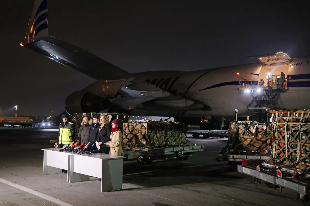 U.S. and Ukrainian officials speak to the media following the unloading of weapons delivered by the U.S. military to Ukraine, on Jan. 25, 2022. (Sean Gallup/Getty Images)