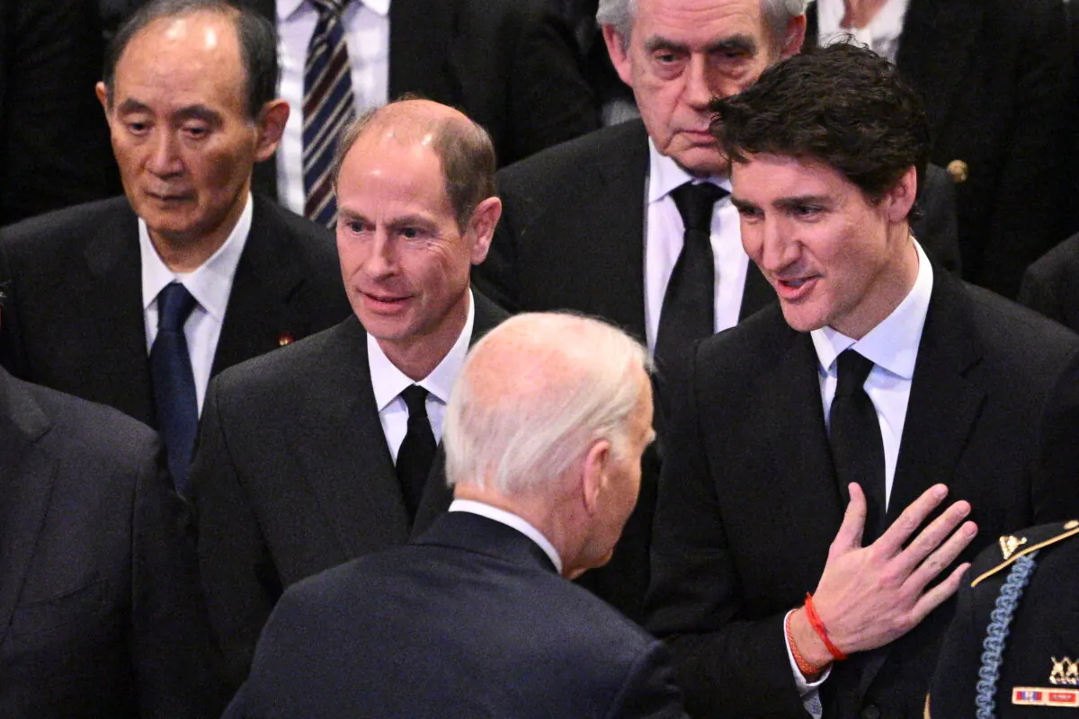 U.S. President Joe Biden chats with Canadian Prime Minister Justin Trudeau as he departs the State Funeral Service for former U.S. President Jimmy Carter at the Washington National Cathedral in Washington on Jan. 9, 2025. (Mandel Ngan/AFP via Getty Images)