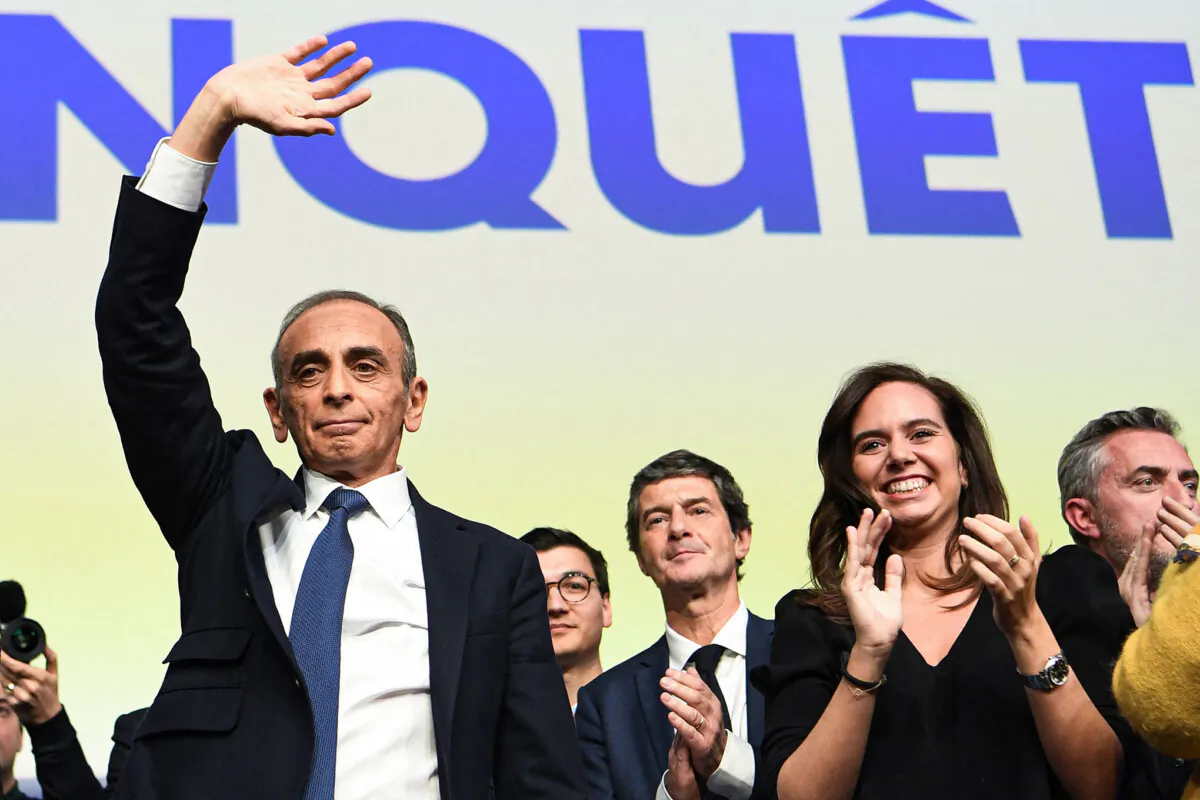 French Reconquete! party presidential candidate Eric Zemmour (L) waves at supporters next to adviser Sarah Knafo (R) in Paris on April 10, 2022. (Bertrand Guay/AFP via Getty Images)