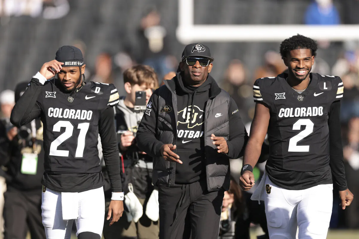 (L-R) Shilo Sanders (21), Head coach Deion Sanders and Shedeur Sanders (2) of the Colorado Buffaloes walk the field during senior day celebrations prior to the game against the Oklahoma State Cowboys at Folsom Field in Boulder, Colo., on Nov. 29, 2024. (Andrew Wevers/Getty Images)