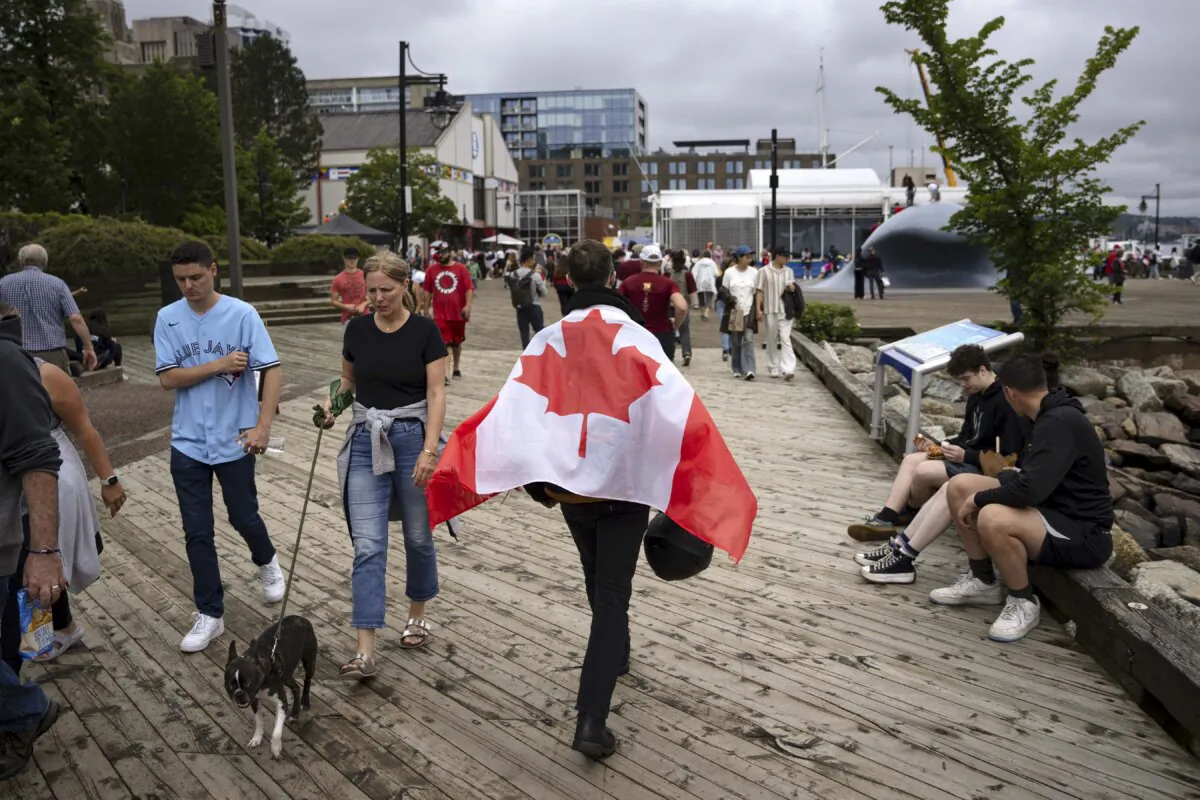 People walk along the waterfront in Halifax on Canada Day, July 1, 2024. (The Canadian Press/Darren Calabrese)