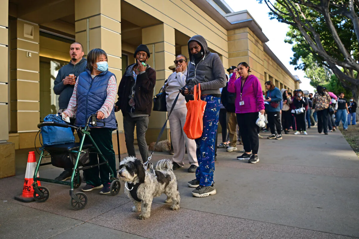 People arrive with their pets at an evacuation center in the Pasadena Convention Center as they flee wildfires in the Los Angeles area, in Pasadena, Calif., on Jan. 10, 2025. (Agustin Paullier/AFP via Getty Images)