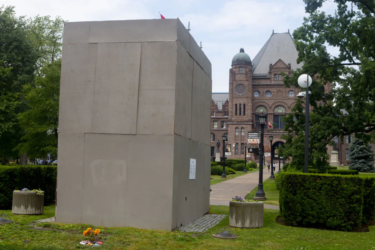 A boxed-up statue of Sir John A. MacDonald, stands on the grounds of the Ontario legislature at Queen's Park, in Toronto, June 18, 2021.  (THE CANADIAN PRESS/Chris Young)