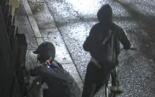Police believe these 2 individuals spray painted graffiti on the fence and building, while also attempting to light a fire at the Newtown Synagogue in Sydney, Australia, at 4:25 a.m. on Jan. 11, 2025. (NSW Police)