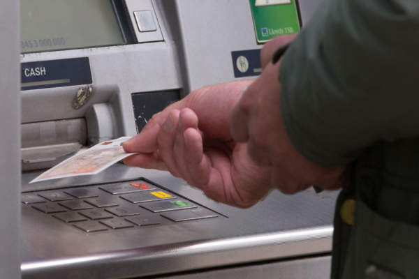 File photo of a person withdrawing money from an ATM on Sep. 14, 2017. (PA Wire/PA Images)