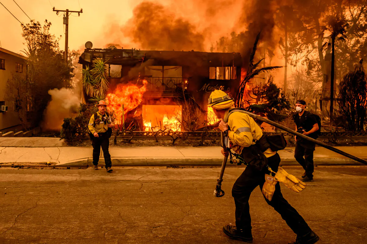 Firefighters work the scene as an apartment building burns during the Eaton fire in the Altadena area of Los Angeles County, on Jan. 8, 2025. (Josh Edelson/AFP via Getty Images)